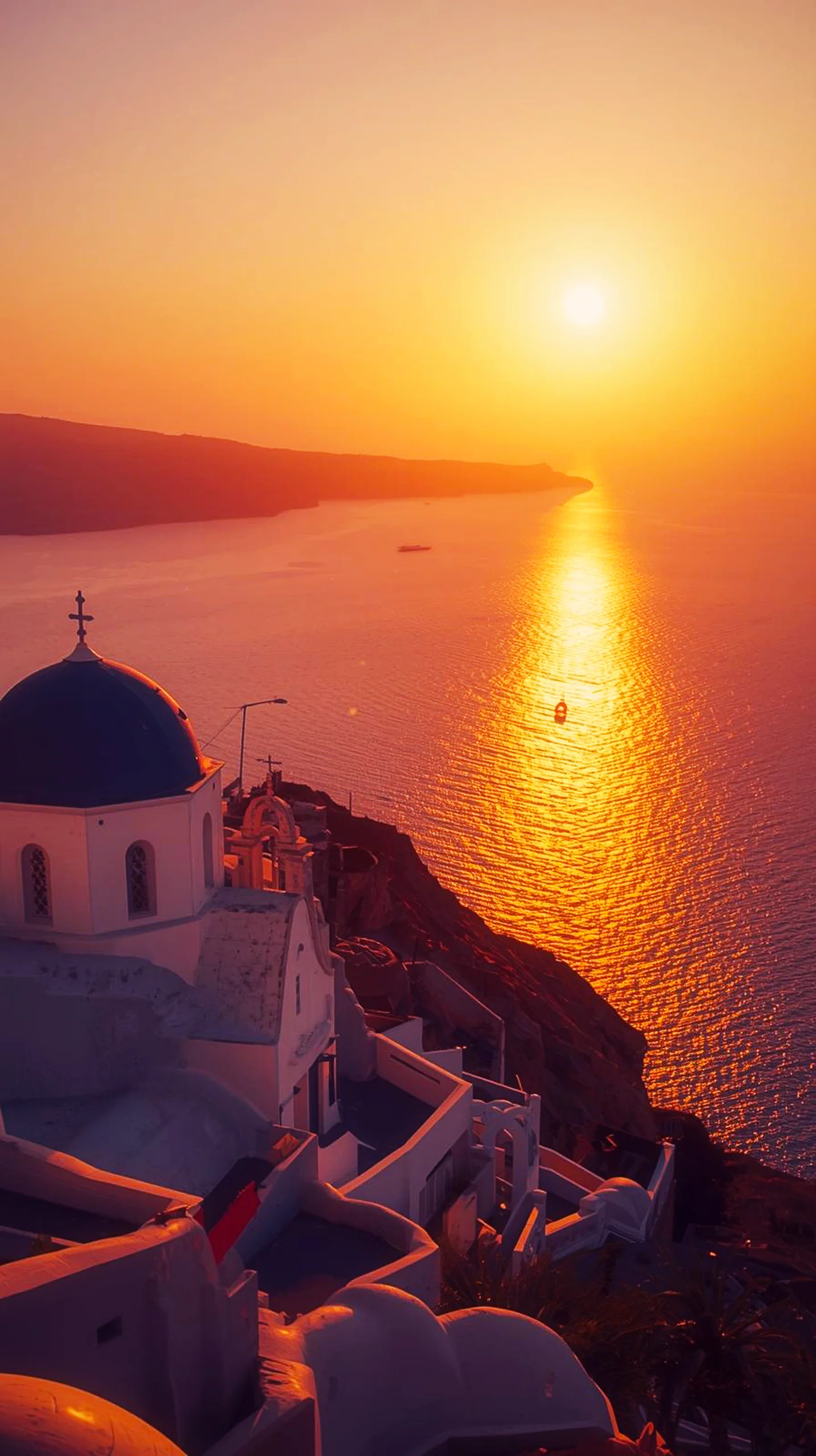 A beautiful 4K mobile wallpaper of a Santorini sunset over the sea with a blue-domed church in the foreground.