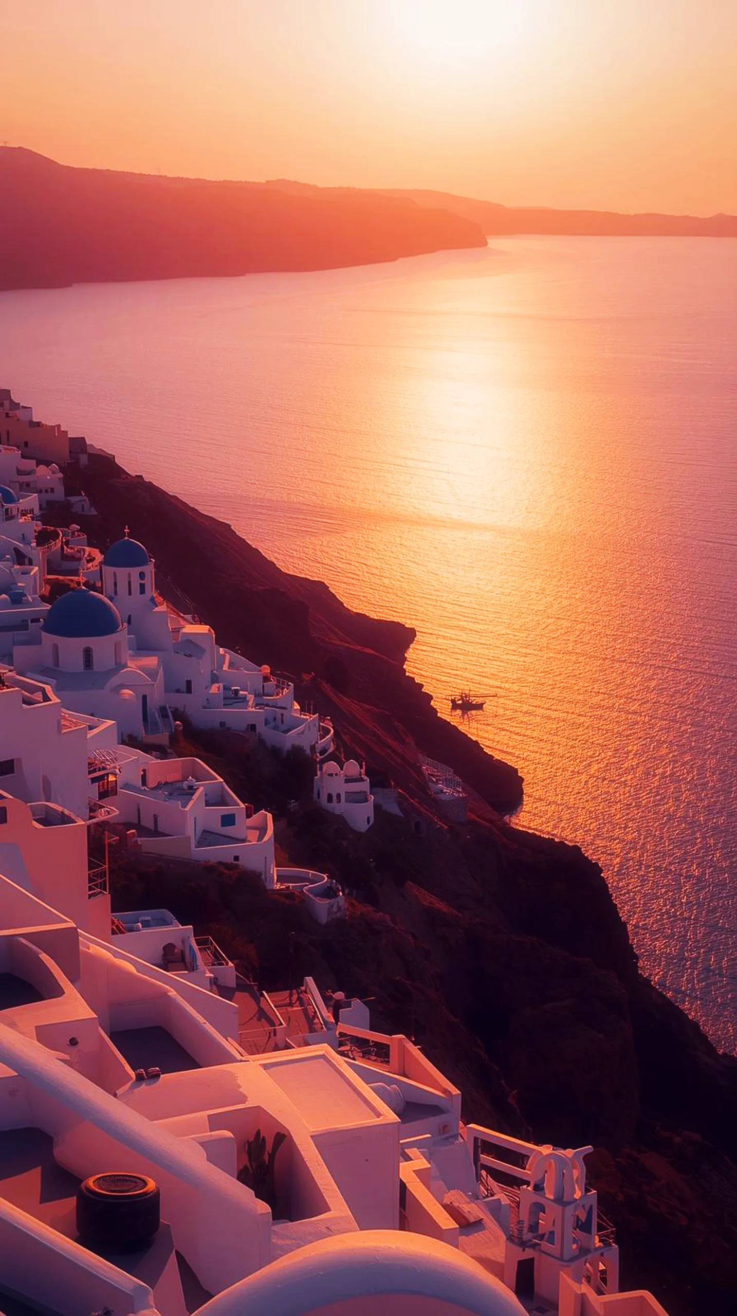 A stunning 4K mobile wallpaper of a golden sunset over the white buildings of Santorini, Greece.