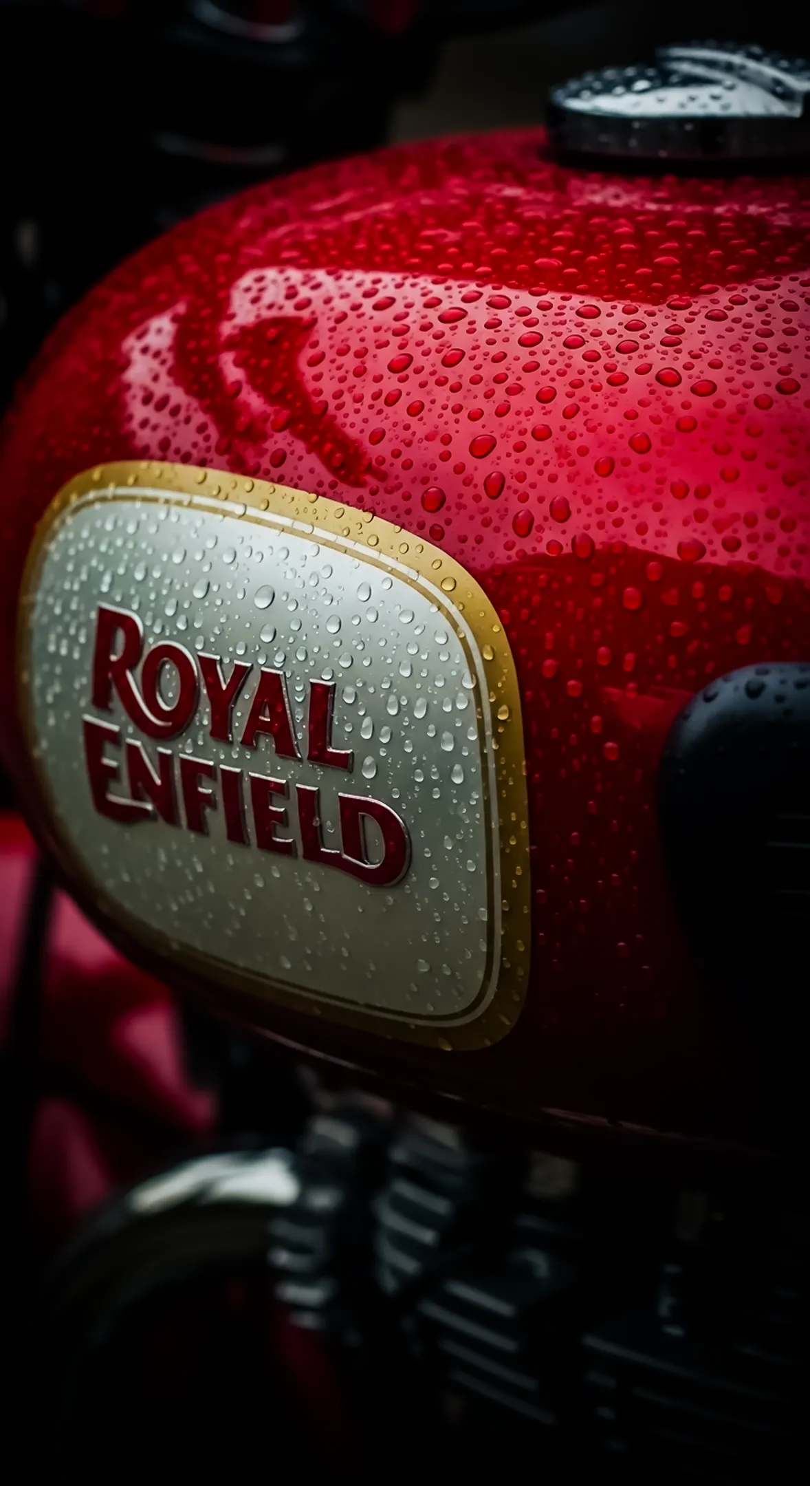 Royal Enfield red motorcycle tank with raindrops. Great 4k wallpaper for iphone, phone wallpaper, and 4k backgrounds
