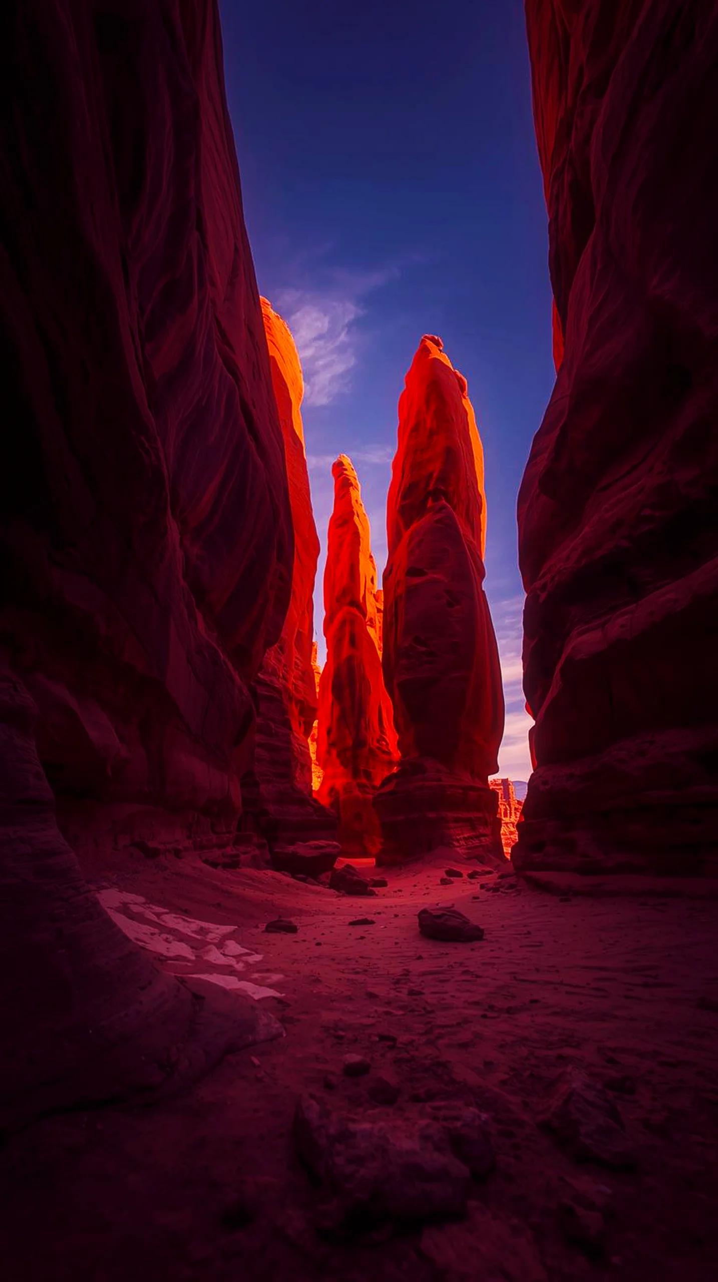 iPhone wallpaper 4k of red rock spires in a canyon, bathed in sunlight, against a blue sky. 4K wallpaper for mobile,