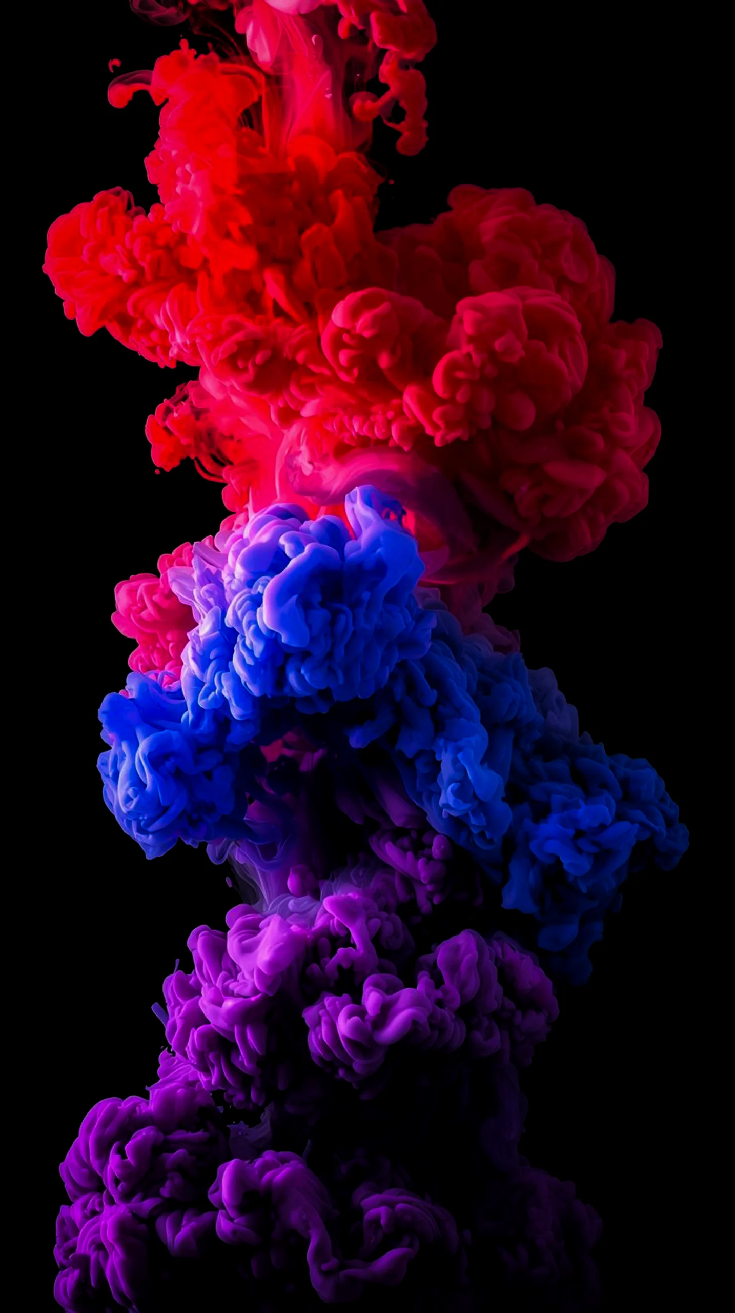 Abstract 4K AMOLED wallpaper with swirling red, blue, and purple ink clouds on a black background. Ideal for iPhone and