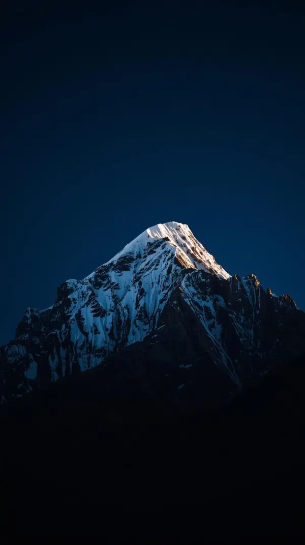 iphone wallpaper 4k Majestic Snow-Capped Himalayan Peak at Twilight Golden Sunlit Summit Dark Blue Night Sky Dramatic Mo