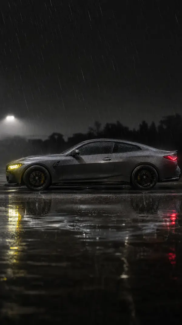 Dark Grey Sports Coupe Parked on Rainy Asphalt at Night