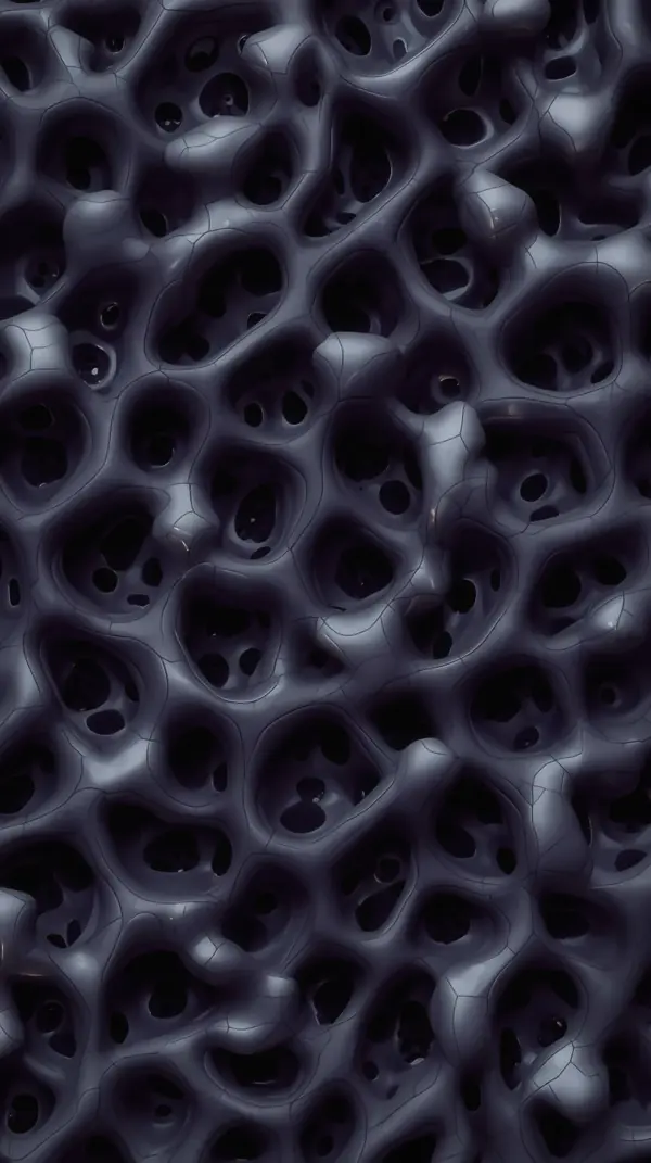 dark gray porous organic structure with glossy cellular textures under soft light