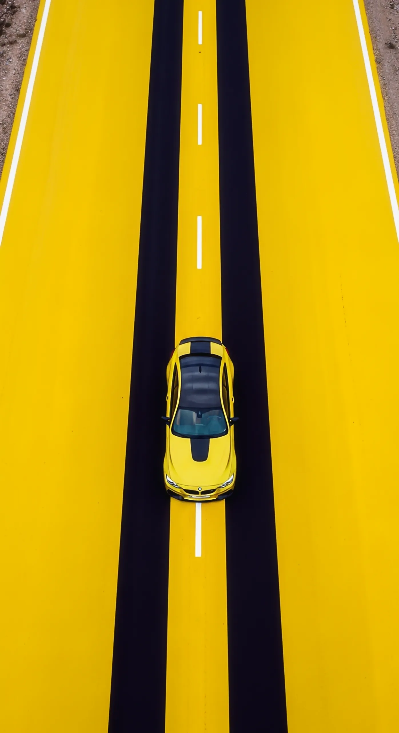 Yellow car iphone wallpaper 4k for mobile, featuring a yellow car on a yellow and black road. A vibrant car wallpaper4k